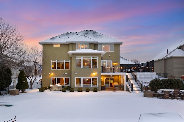 view of snow covered rear of property