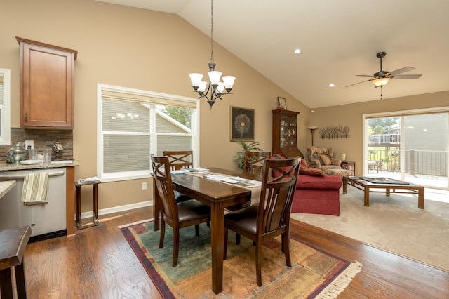 dining room with ceiling fan with notable chandelier, dark hardwood / wood-style floors, and lofted ceiling