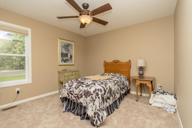 bedroom featuring ceiling fan and light colored carpet