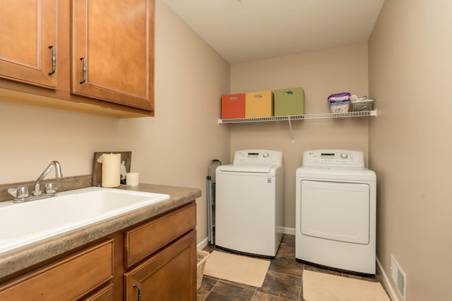 laundry room featuring washer and clothes dryer, cabinets, and sink