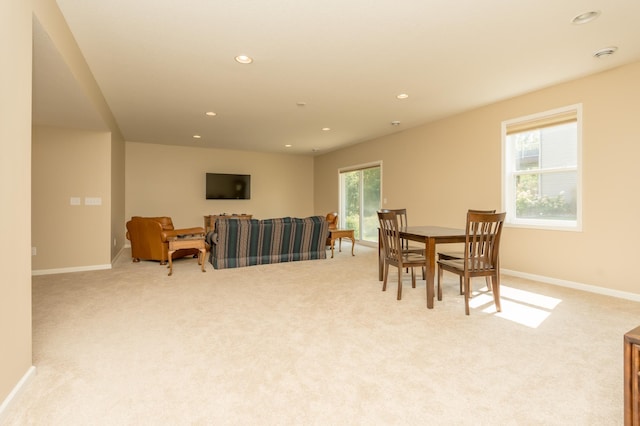 dining space featuring light colored carpet