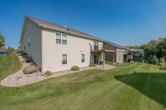 back of house featuring a yard and a wooden deck