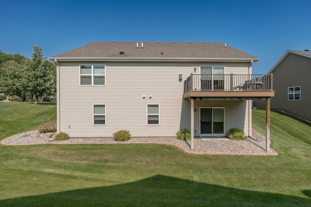 rear view of property featuring a deck and a yard