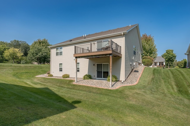 rear view of house featuring a lawn and a wooden deck