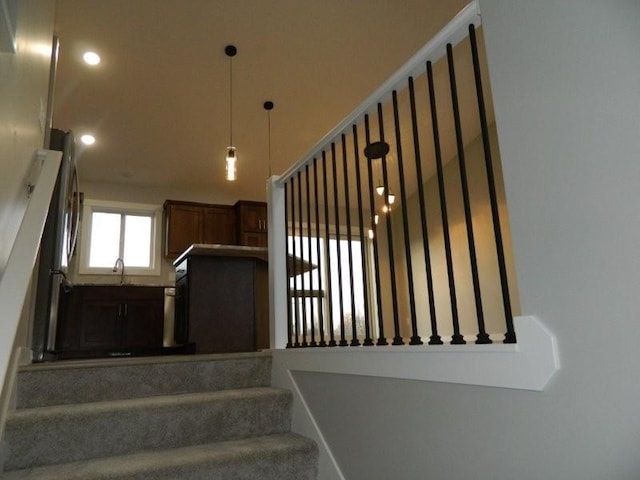 stairway featuring sink