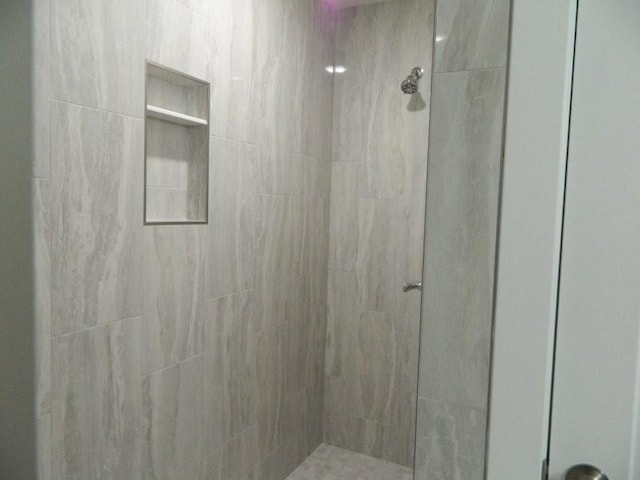 bathroom with tiled shower