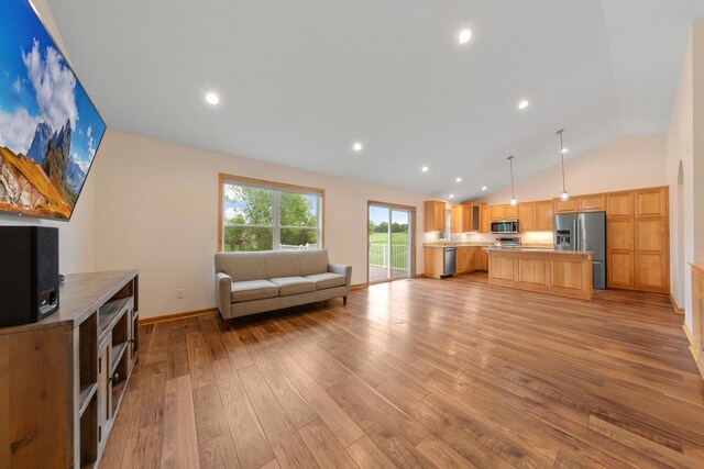 1939 Legacy Dr, Faribault, MN 55021 - living room with lofted ceiling, light wood-style floors, recessed lighting, and baseboards