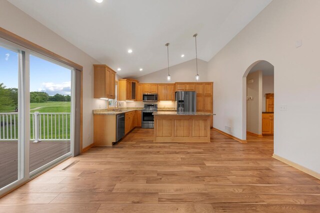 1939 Legacy Dr, Faribault, MN 55021 - kitchen featuring stainless steel appliances, light wood-type flooring, vaulted ceiling, recessed lighting, and a kitchen island