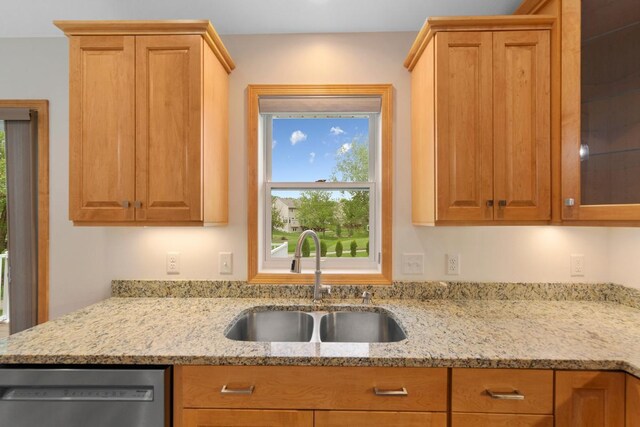 1939 Legacy Dr, Faribault, MN 55021 - kitchen with stainless steel dishwasher, a sink, light stone countertops, and glass insert cabinets