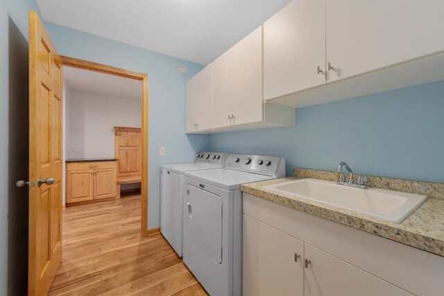 1939 Legacy Dr, Faribault, MN 55021 - washroom featuring washing machine and clothes dryer, cabinet space, and light wood-type flooring
