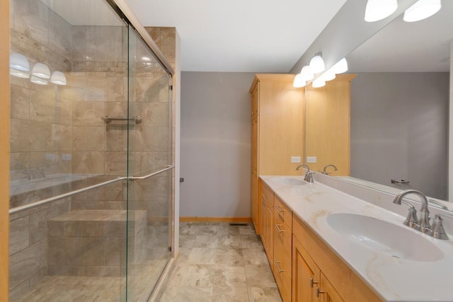 1939 Legacy Dr, Faribault, MN 55021 - full bathroom featuring double vanity, a stall shower, and baseboards