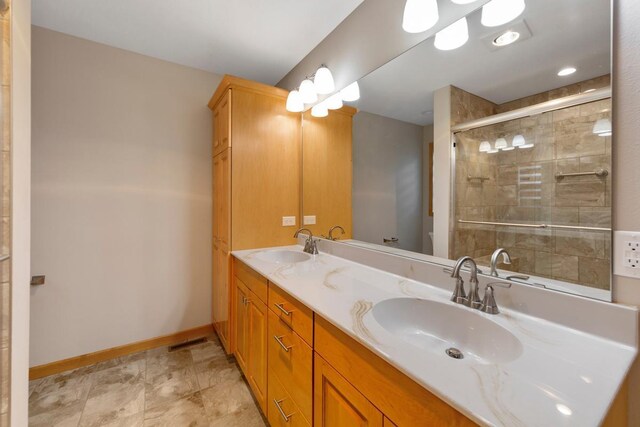 1939 Legacy Dr, Faribault, MN 55021 - full bathroom with double vanity, a shower stall, and baseboards