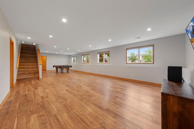1939 Legacy Dr, Faribault, MN 55021 - unfurnished living room featuring billiards, light wood-type flooring, recessed lighting, stairway, and baseboards