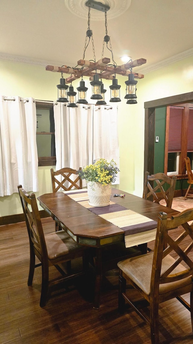 dining space with ornamental molding and hardwood / wood-style floors