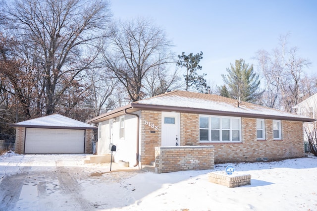 view of front of home with a garage and an outbuilding