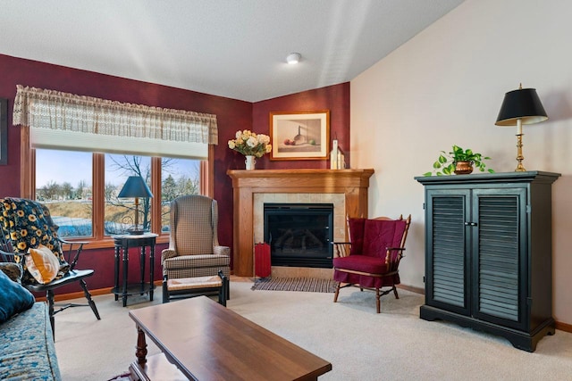 living room featuring a tile fireplace, a textured ceiling, light carpet, and vaulted ceiling