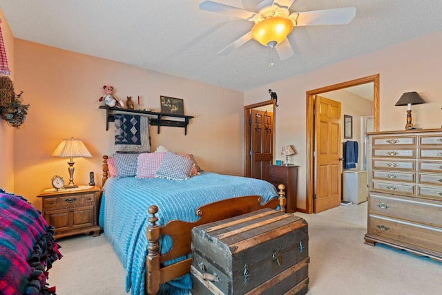 carpeted bedroom with a textured ceiling and ceiling fan