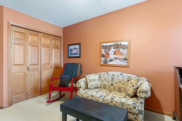 living area featuring a textured ceiling and carpet