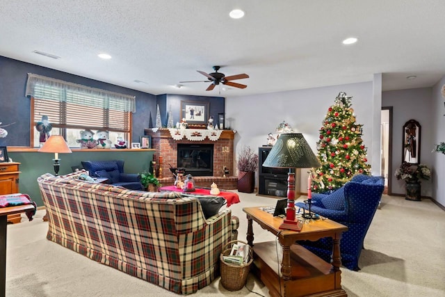 carpeted living room featuring a textured ceiling, ceiling fan, and a brick fireplace