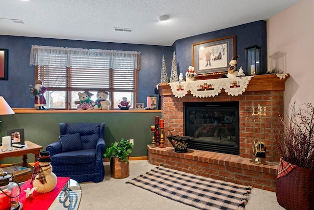 living room featuring a fireplace, a textured ceiling, and carpet floors