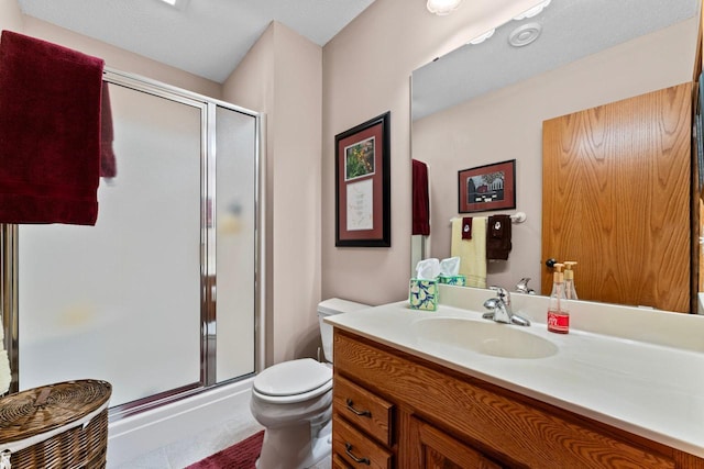 bathroom featuring walk in shower, vanity, and toilet