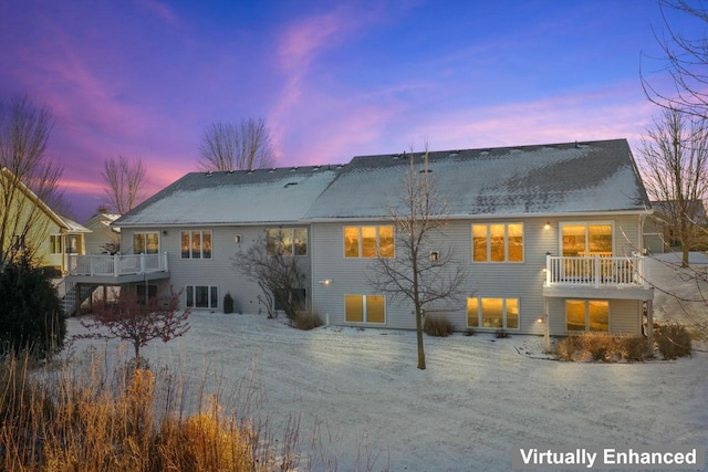 back house at dusk with a wooden deck