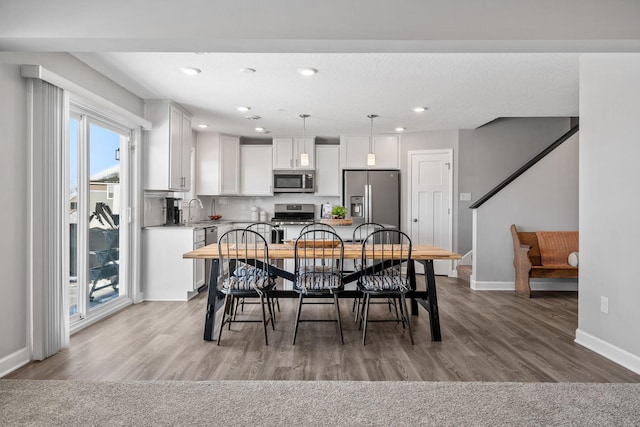 dining room featuring wood-type flooring and sink