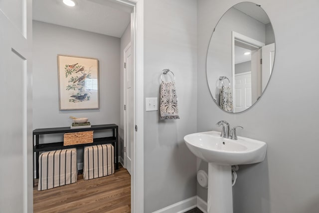 bathroom with hardwood / wood-style flooring and sink