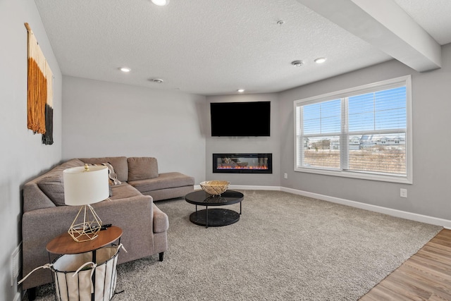 living room with hardwood / wood-style flooring and a textured ceiling