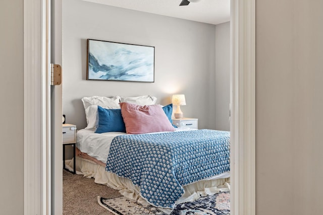 bedroom featuring ceiling fan and carpet