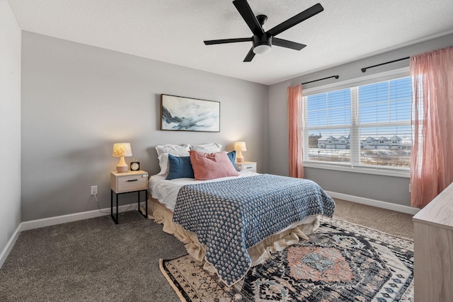 bedroom with dark carpet, a textured ceiling, and ceiling fan