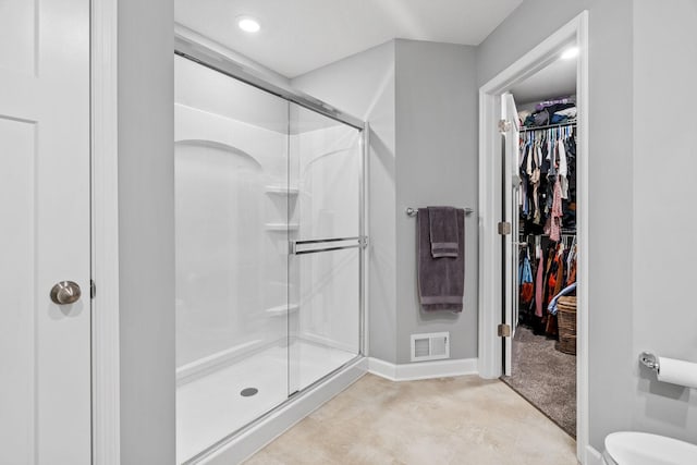 bathroom featuring a shower with shower door