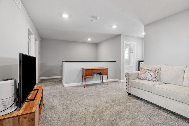 carpeted living room featuring a textured ceiling