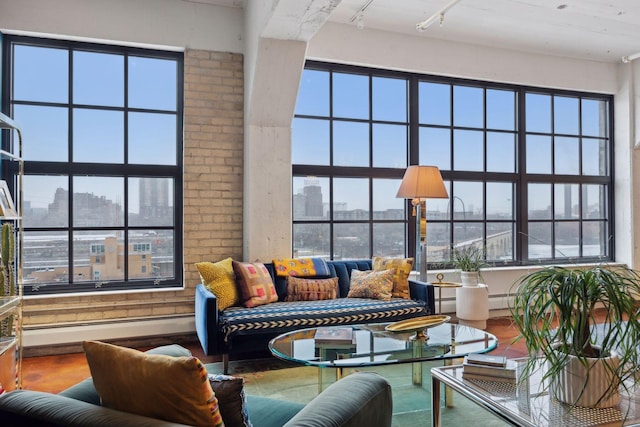 living room featuring hardwood / wood-style flooring, rail lighting, and a high ceiling