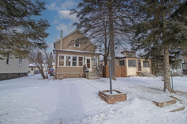 view of snow covered rear of property