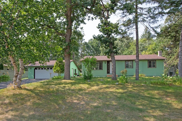 ranch-style house with a front yard and a garage