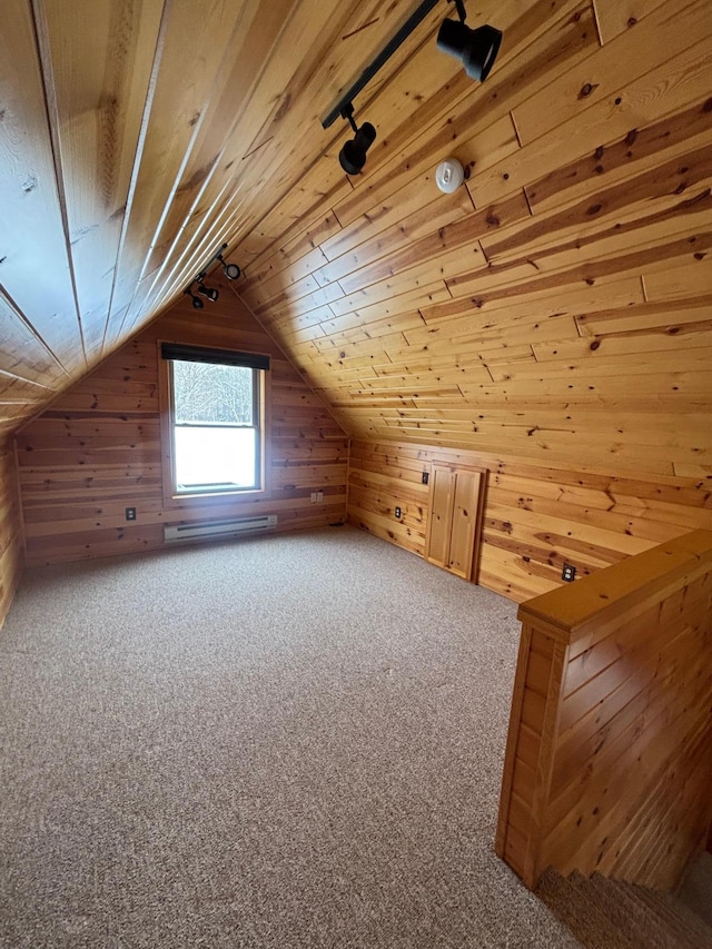 additional living space featuring vaulted ceiling, wooden ceiling, and wooden walls