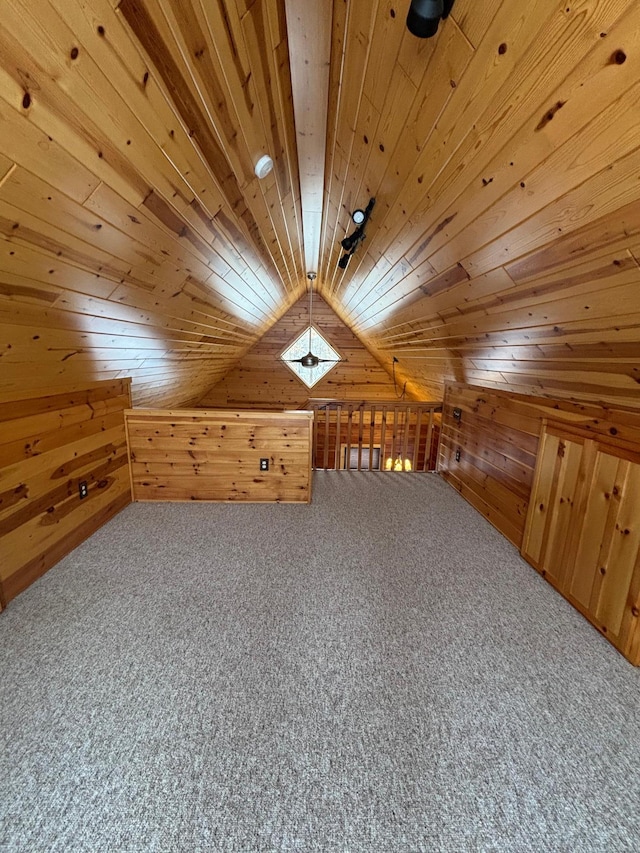 additional living space featuring lofted ceiling, carpet, wood ceiling, and wooden walls