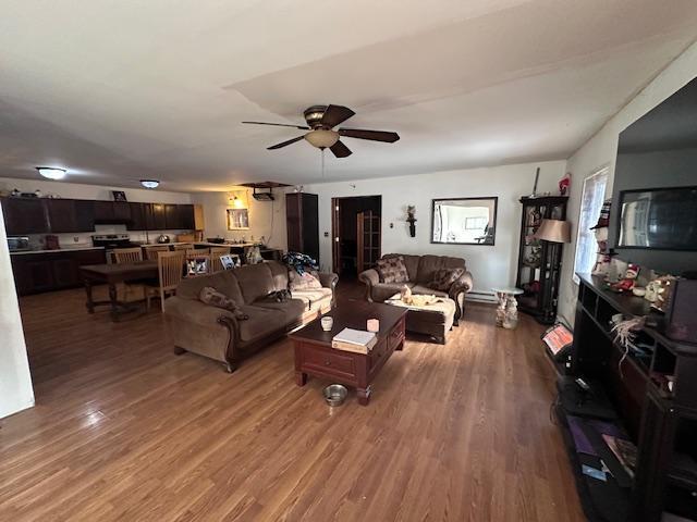 living room featuring ceiling fan and hardwood / wood-style flooring