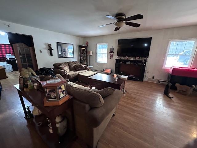 living room featuring wood-type flooring and ceiling fan