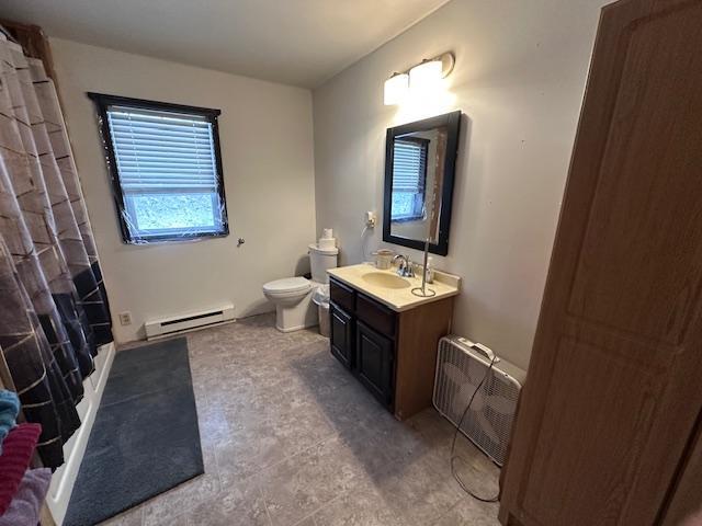 bathroom with vanity, a shower with curtain, toilet, a baseboard radiator, and radiator heating unit