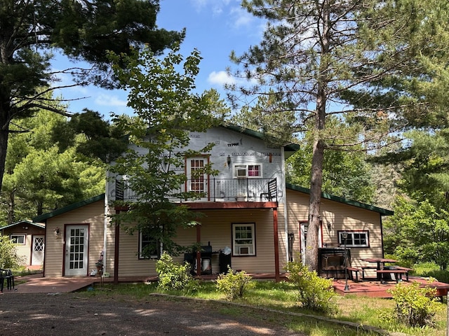 3579 Rodgers Ave E, Eagles Nest Twp, MN 55731 - back of property featuring a wooden deck and a patio