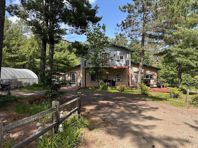 3579 Rodgers Ave E, Eagles Nest Twp, MN 55731 - view of front of home with a greenhouse, driveway, a deck, and an outdoor structure