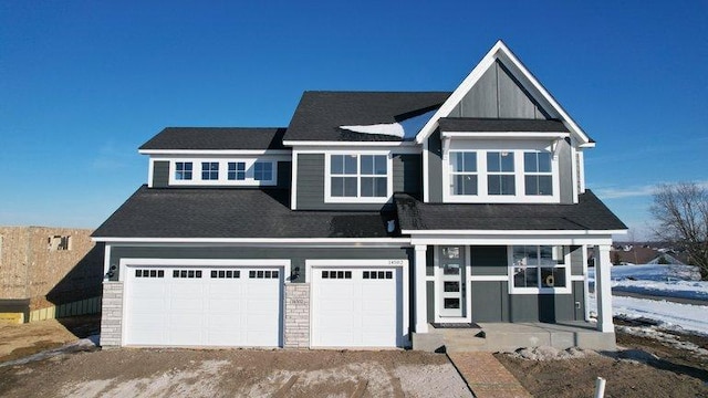 view of front of house featuring a porch and a garage