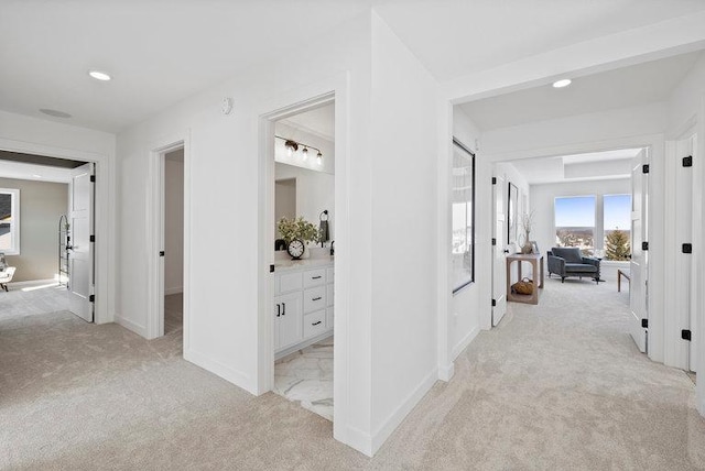 corridor with light colored carpet