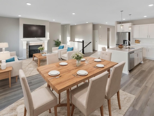 dining area featuring sink and light wood-type flooring