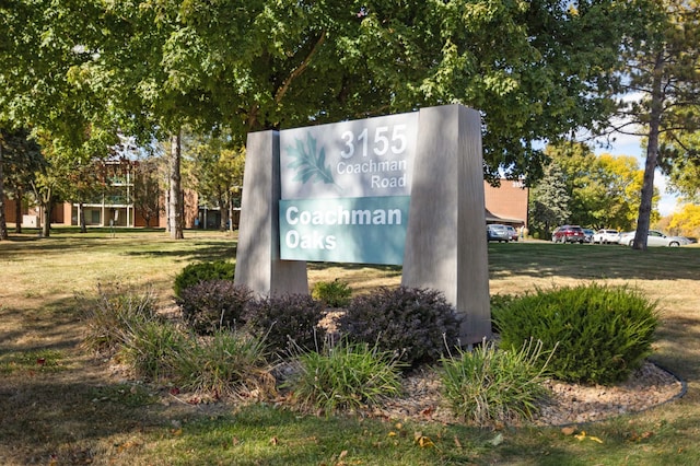 community sign featuring a lawn