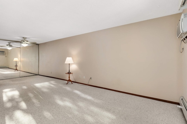 spare room featuring an AC wall unit and a baseboard radiator