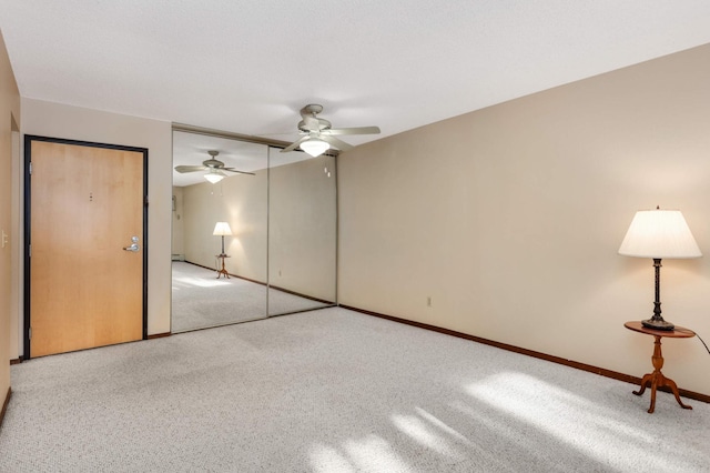 unfurnished bedroom featuring light carpet and ceiling fan