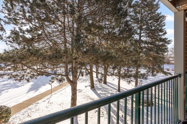 view of snow covered back of property